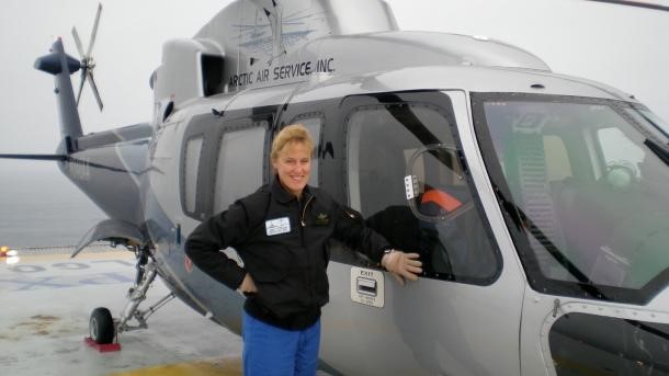 Melissa Mathiasen in front of an S-76A helicopter for offshore oil support.